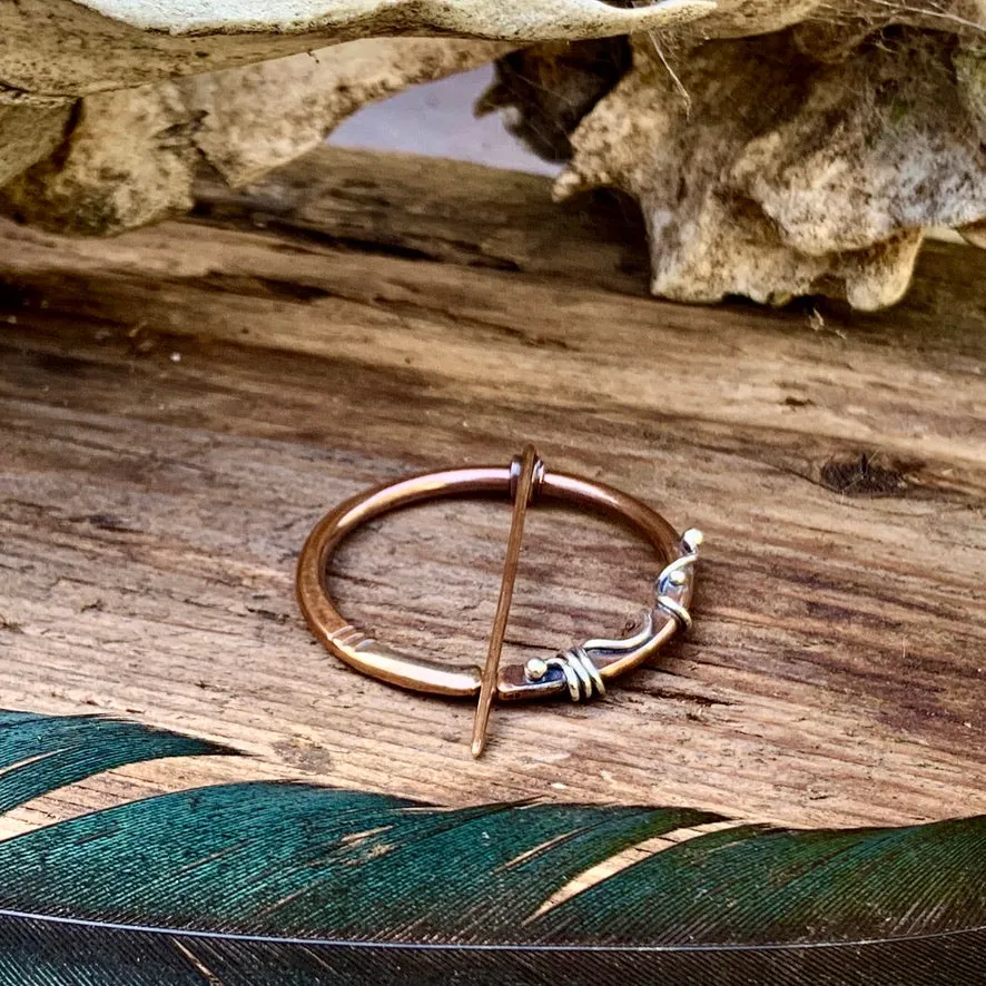 Copper and Sterling silver Pen-annular brooch.