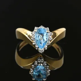 Diamond Halo Pear Cut Blue Topaz Ring in Gold